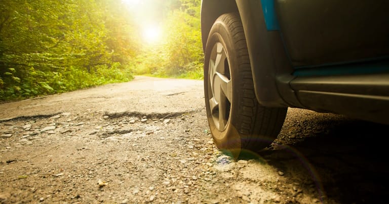 car driving over bumpy terrain